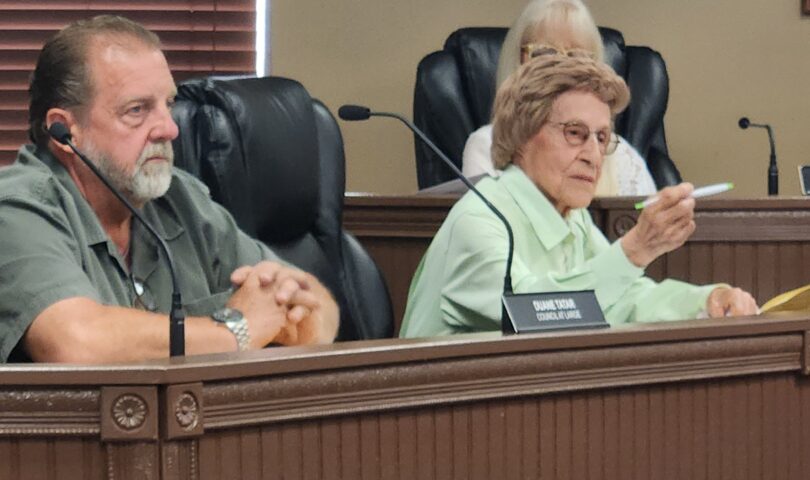 Duane Tatar looks on as Edie Viola offers remarks during her final meeting after 28 years on Westover City Council.